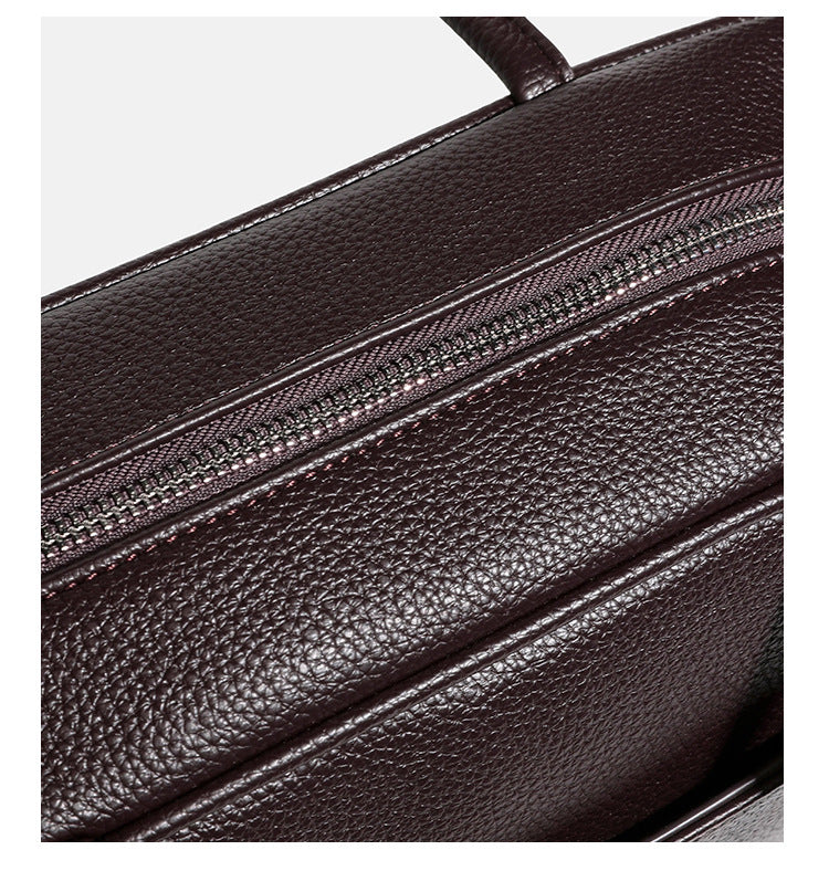 Structured rounded rectangular shoulder bag with pebbled leather-look finish, dual long handles, top zipper, front zip