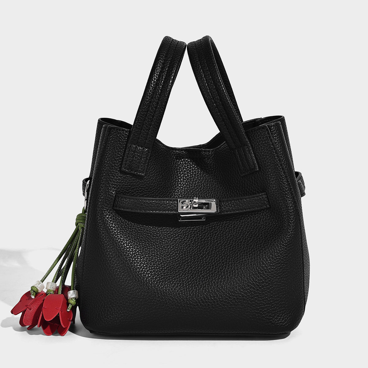 Small structured pebbled bucket tote bag with dual top handles, silver turn-lock front pocket, and detachable shoulder strap