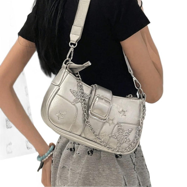 Compact metallic silver shoulder bag with glitter star appliqués, rhinestone star charms, front belt buckle strap, chunky