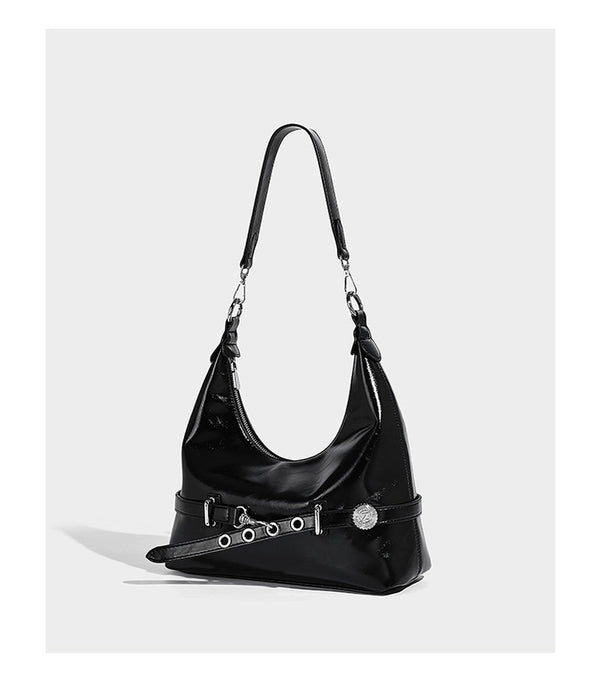 Glossy black slouchy hobo shoulder bag with silver-tone hardware, belt-style grommet strap at base, and long adjustable
