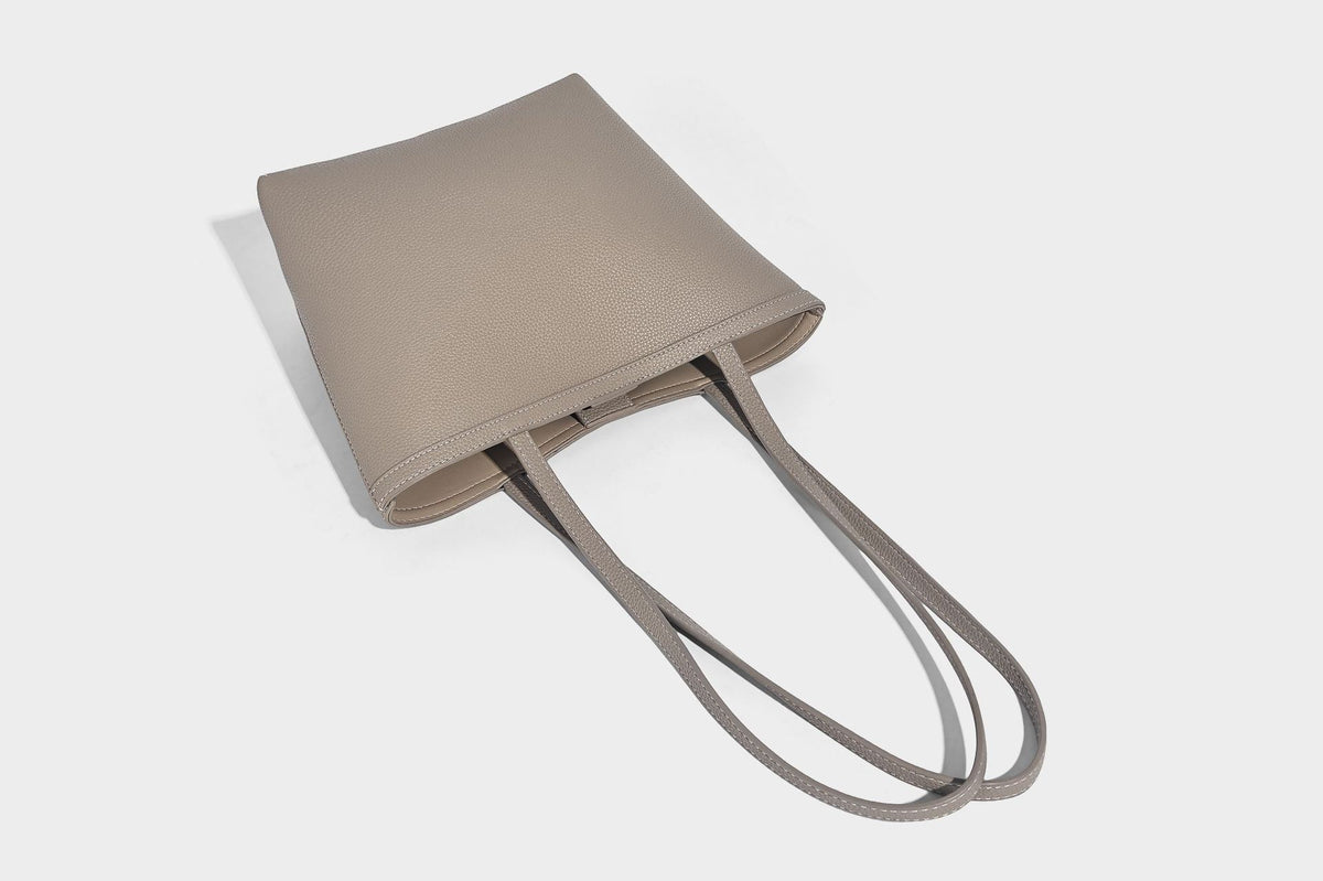 Structured pebbled leather-look tote bag in taupe with long shoulder strap, detachable zip pouch, and pink tulip flower
