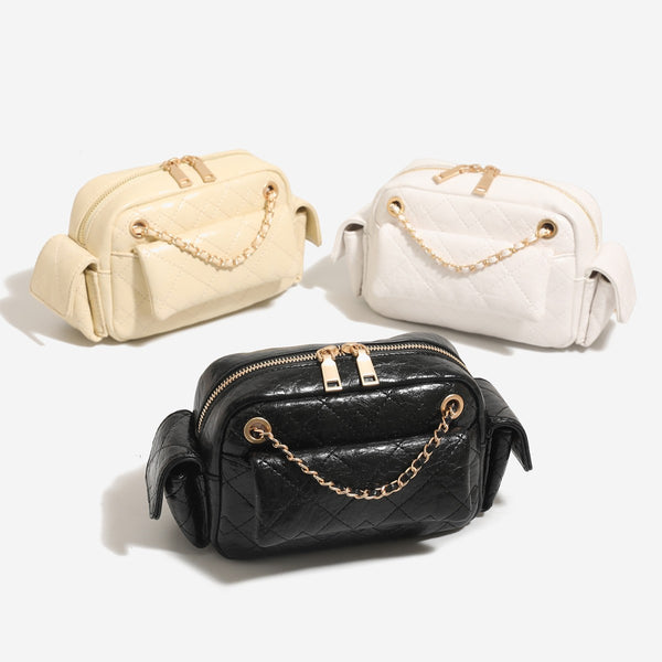 Compact quilted leather-look crossbody bag with gold-tone chain strap and double zip closure, front view