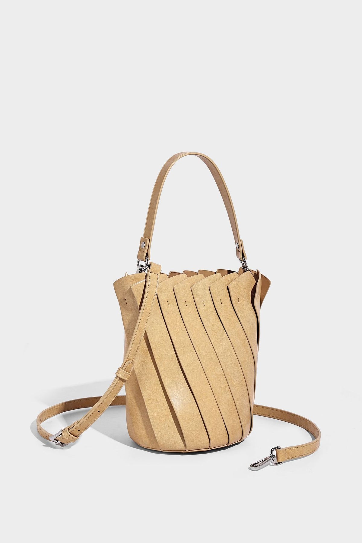 Structured pleated-panel bucket bag with curved top handle and detachable adjustable shoulder strap in smooth matte, detail