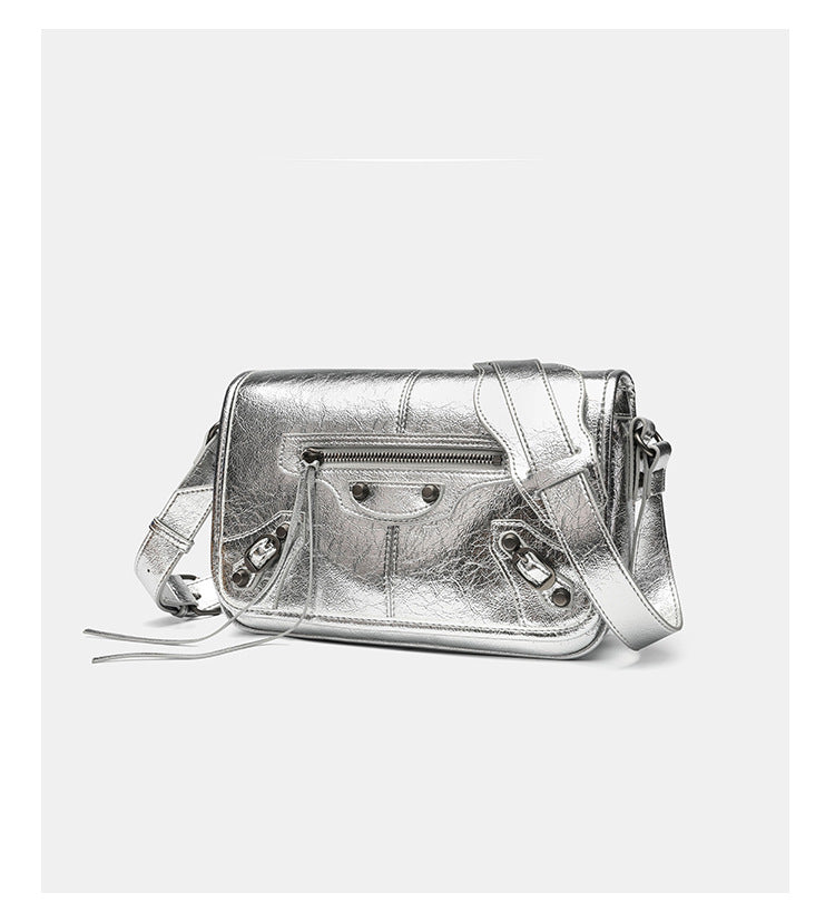 Small structured rectangular crossbody bag with crinkle leather-look finish, front zip pocket, gunmetal stud hardware, and