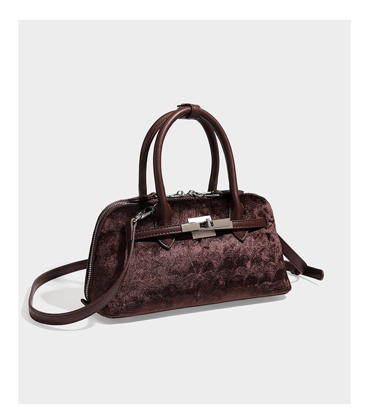 Small structured satchel bag in dark brown velvet-like textured finish with leather-look trim, silver-tone turn-lock bar