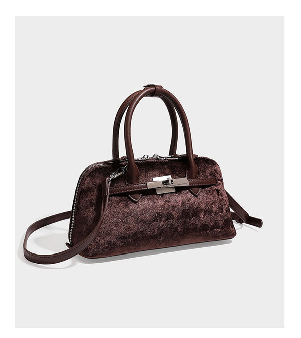 Small structured satchel bag in dark brown velvet-like textured finish with leather-look trim, silver-tone turn-lock bar