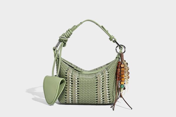 Small woven crescent shoulder bag with leather-look trim, zip closure, silver-tone ring hardware, and beaded tassel charm