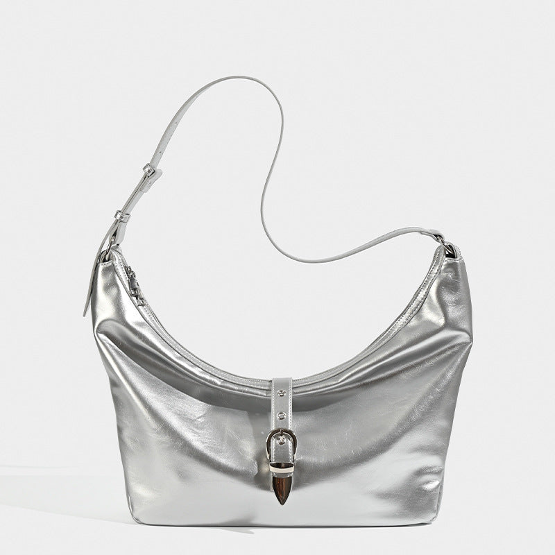 Slouchy crescent hobo bag with glossy leather-look finish, silver-tone buckle hardware, and flat shoulder strap, detail view
