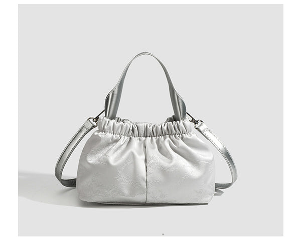 Small ruched satin-finish cloud bag with elasticized drawstring top, short top handle, and chunky silver-tone chain strap