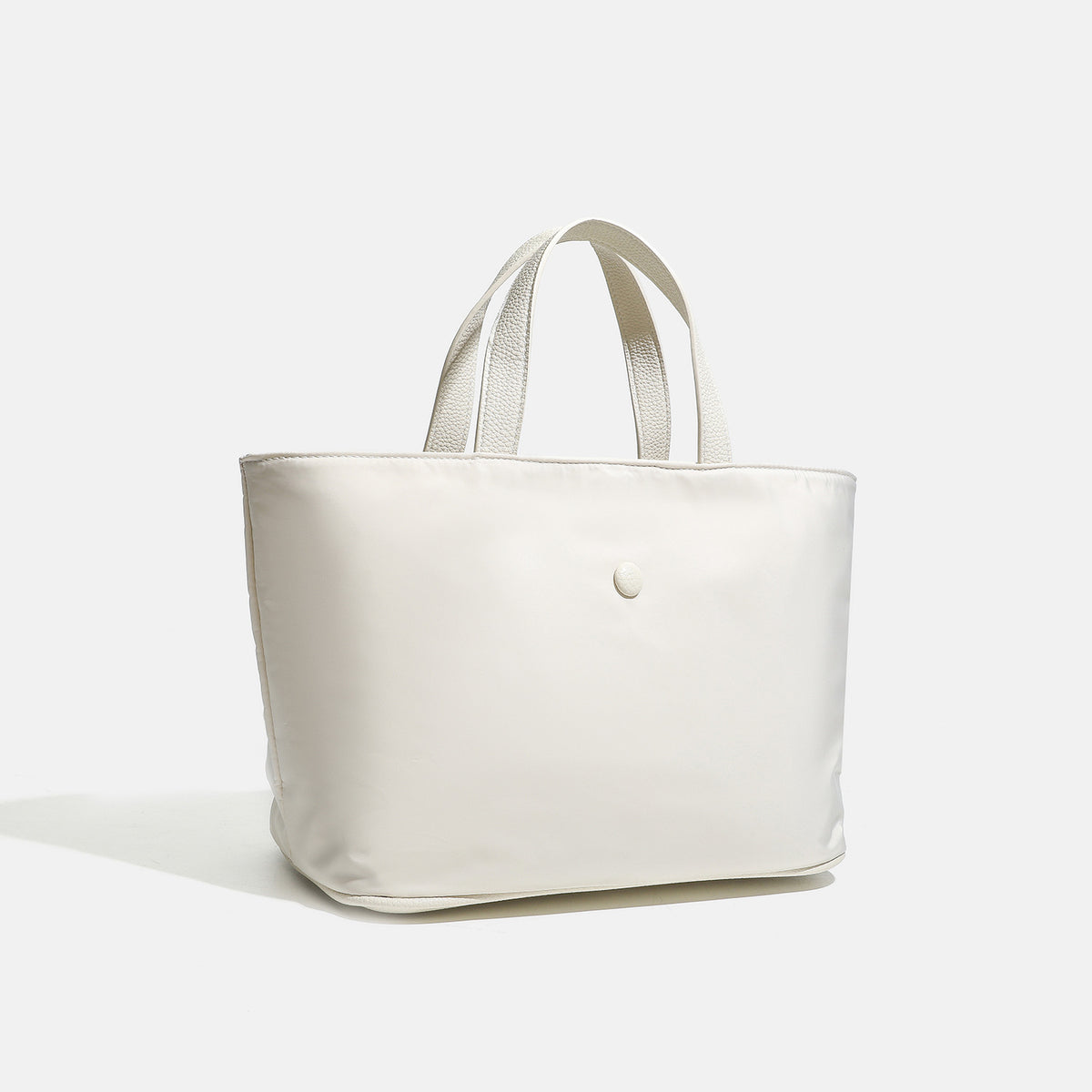 Structured lightweight nylon tote bag with textured double top handles and snap-button front detail, detail view 3