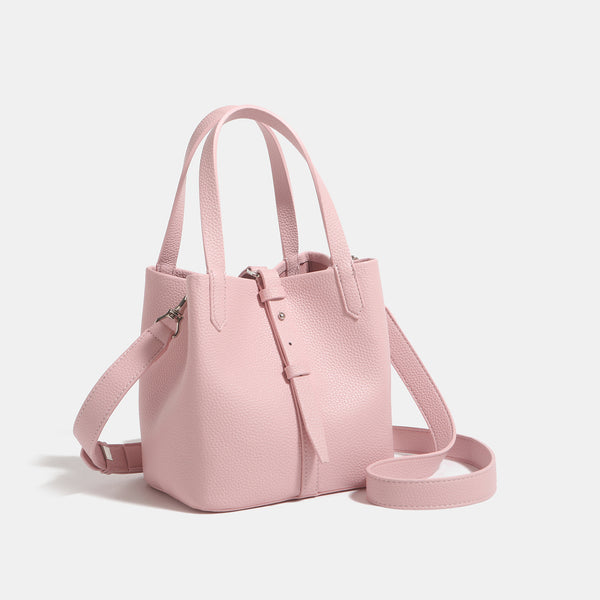 Small structured pebbled leather-look bucket tote bag with dual top handles and silver-tone hardware, detail view 3