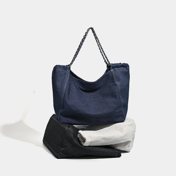 Large slouchy denim tote bag with silver-tone chain strap and contrast topstitching, detail view 2