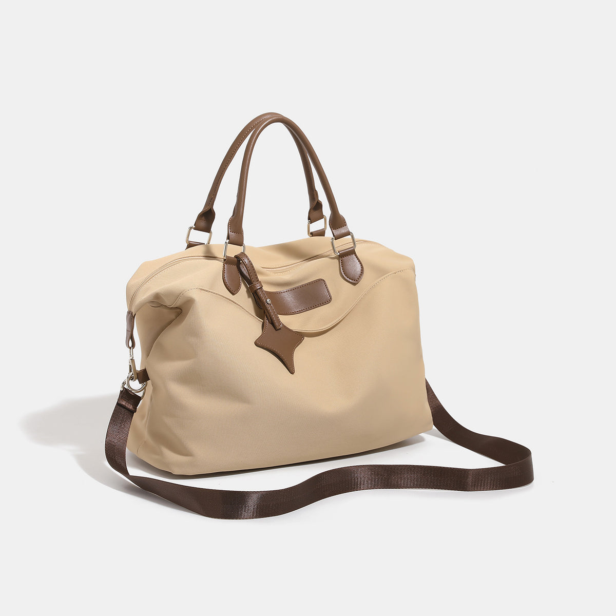 Large slouchy nylon tote bag with brown leather-look handles, double-pull zip closure, and star charm detail, detail view 3