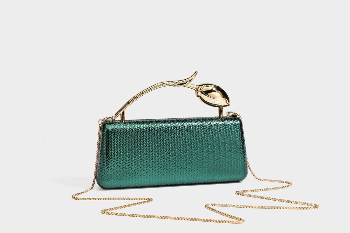 Structured rectangular metallic woven clutch bag with sculptural gold-tone leaf top handle and detachable chain strap, detail