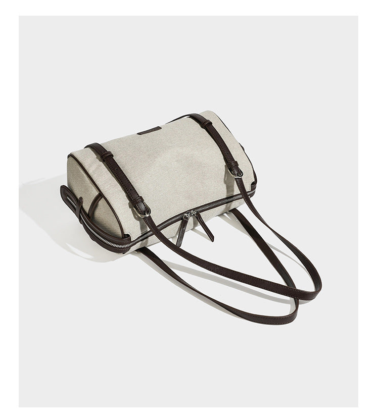 Cream canvas barrel shoulder bag with dark brown leather-look straps, trim, and silver-tone hardware, detail view 12