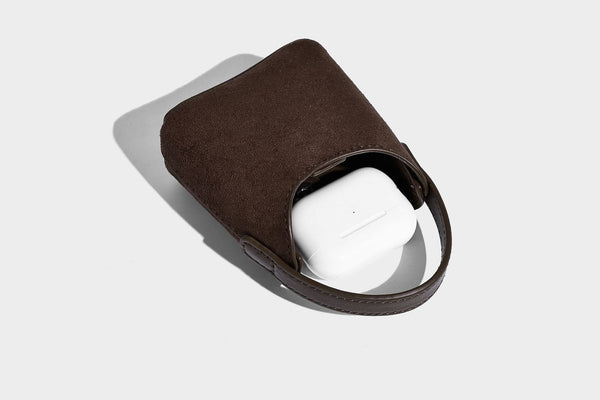 Dark brown suede-look hobo shoulder bag with top zip closure, adjustable strap, and small detachable mini pouch, detail view