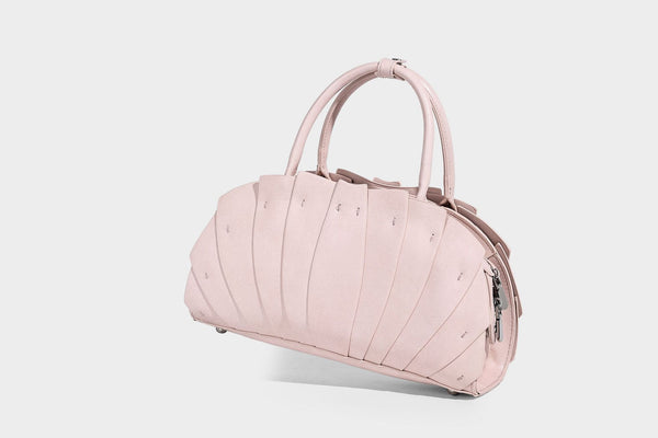 Structured dome satchel with fan-pleated leather-look exterior, dual top handles, and detachable shoulder strap, detail view