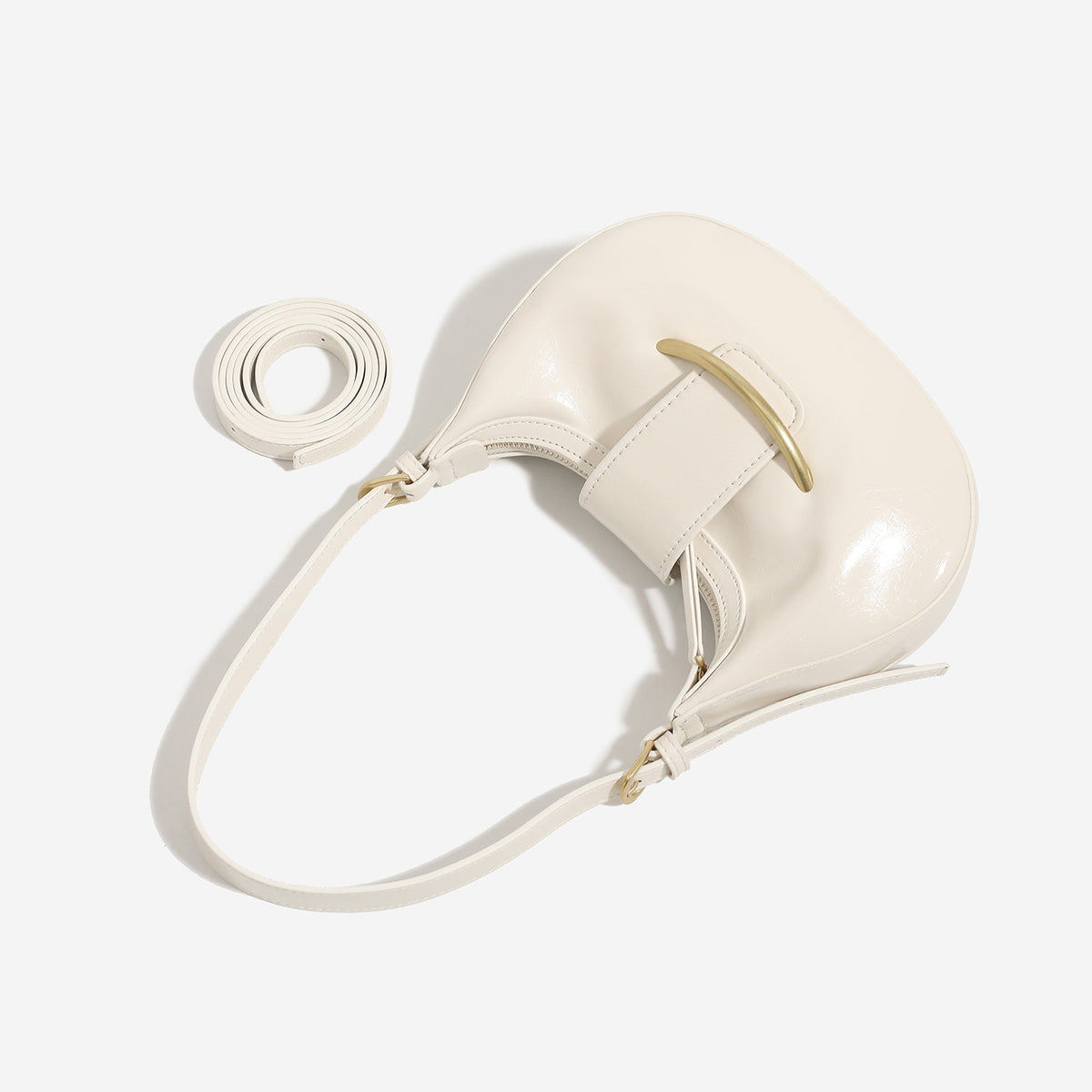 Compact crescent hobo shoulder bag with glossy synthetic finish, curved gold-tone front bar hardware, zip-top closure, and
