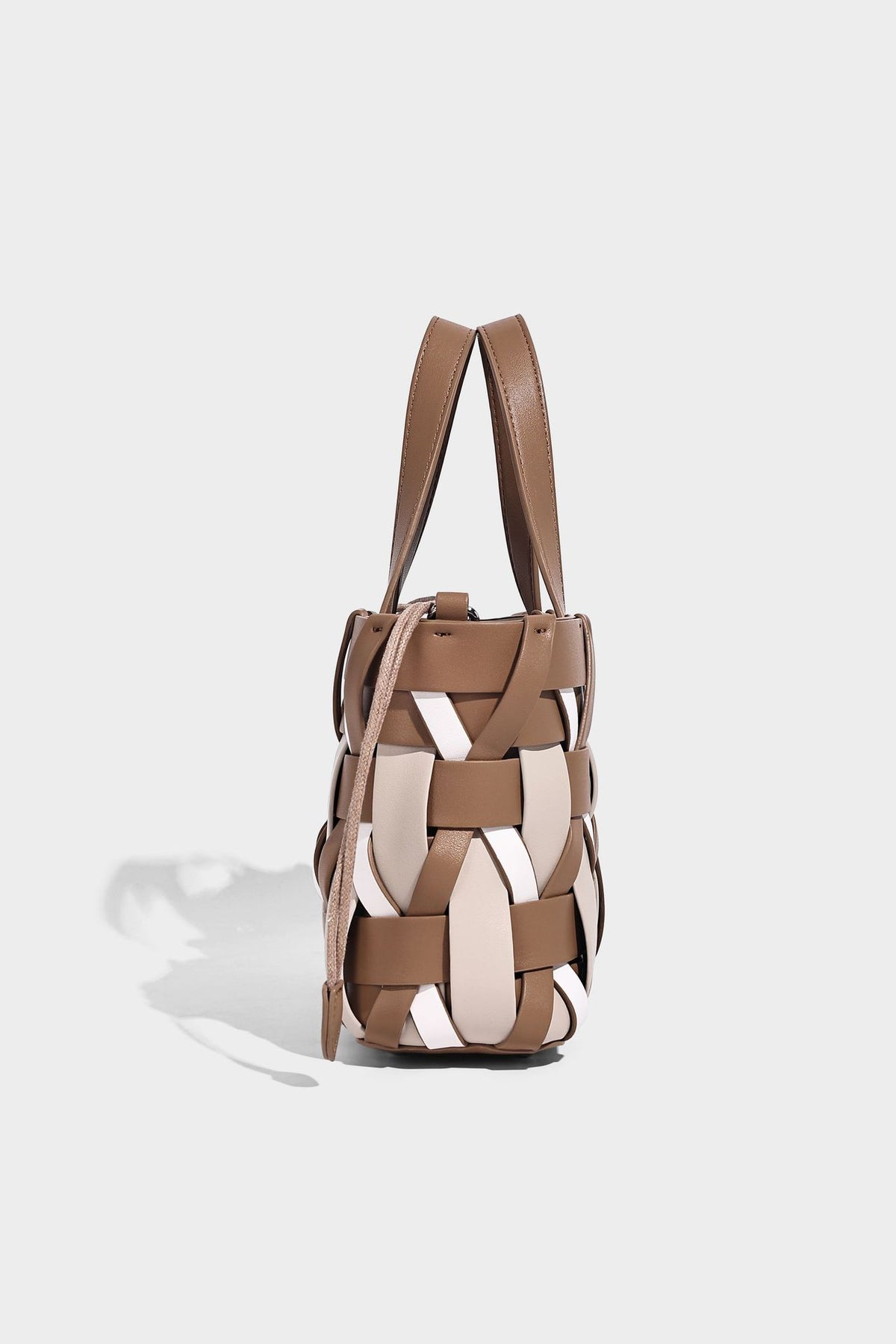 Small structured woven lattice tote bag with dual top handles and detachable shoulder strap in brown and cream leather-look