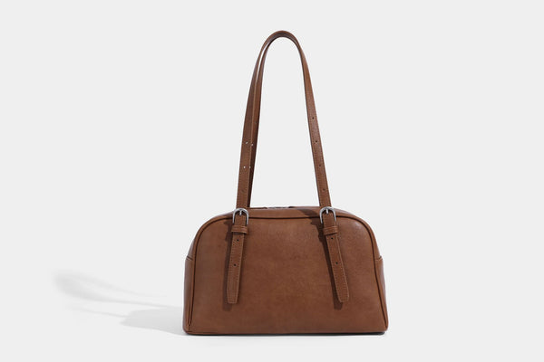 Structured dome-shaped shoulder bag with leather-look finish, top zipper closure, dual adjustable slim straps, and, detail
