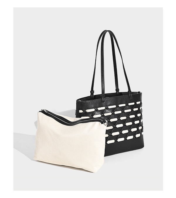 Structured woven lattice cutout tote bag with smooth leather-look trim, dual shoulder straps, and silver-tone hardware