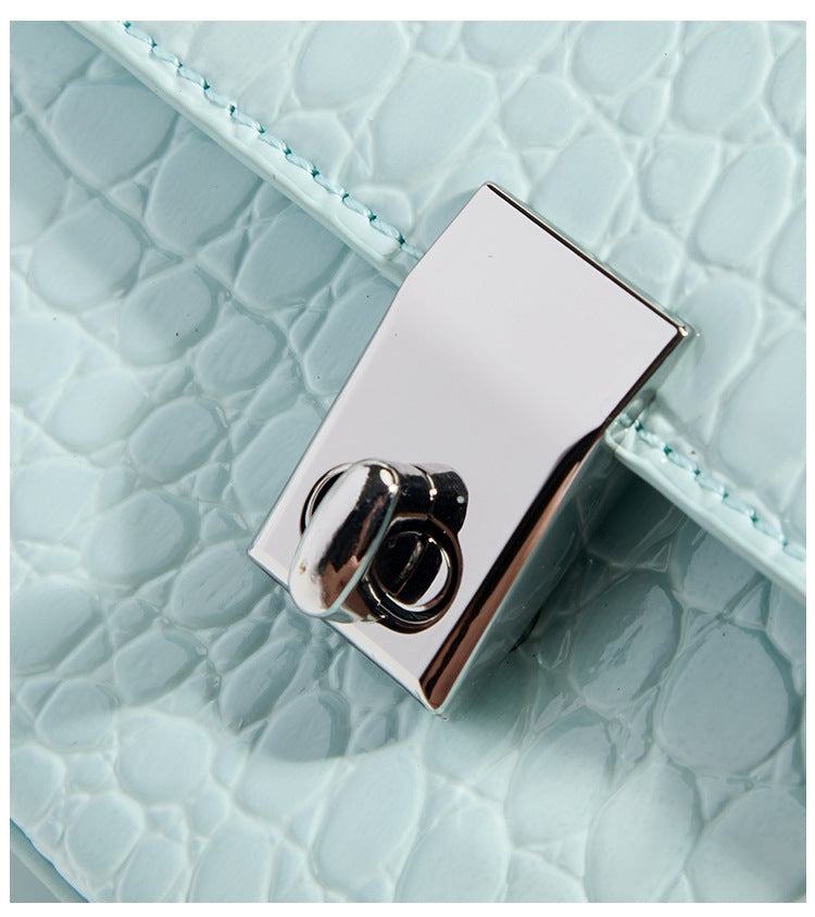 Glossy croc-embossed mini saddle bag with silver-tone turn-lock clasp and short top handle, detail view 12