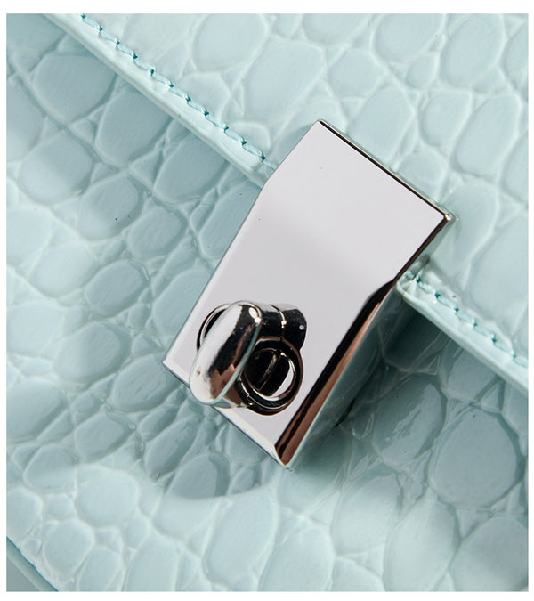 Glossy croc-embossed mini saddle bag with silver-tone turn-lock clasp and short top handle, detail view 12
