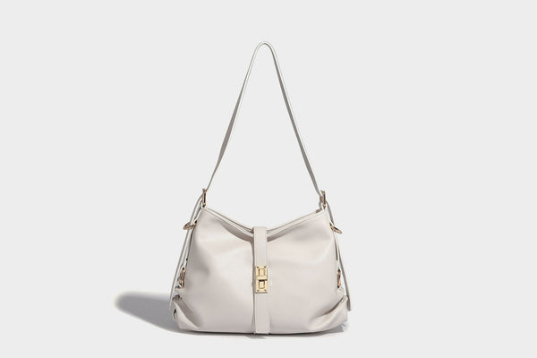 Soft slouchy hobo shoulder bag with smooth leather-look finish, gold-tone buckle and tab hardware, and long adjustable strap
