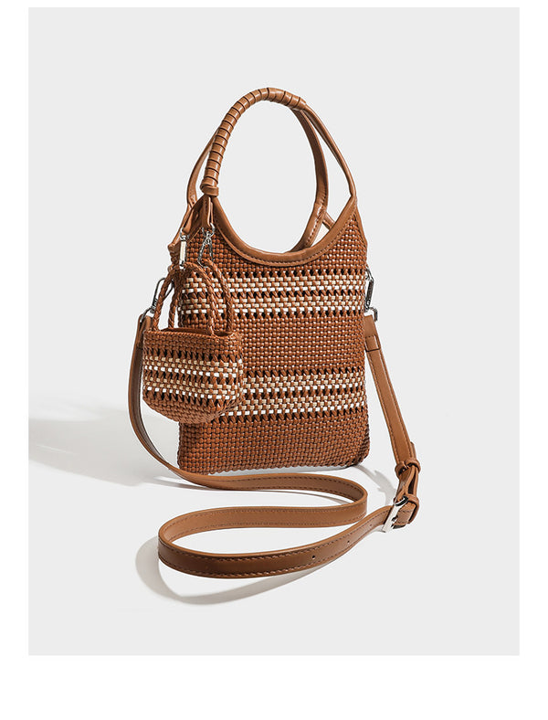 Brown two-tone woven leather-look shoulder bag with braided top handles, detachable mini pouch, and adjustable crossbody