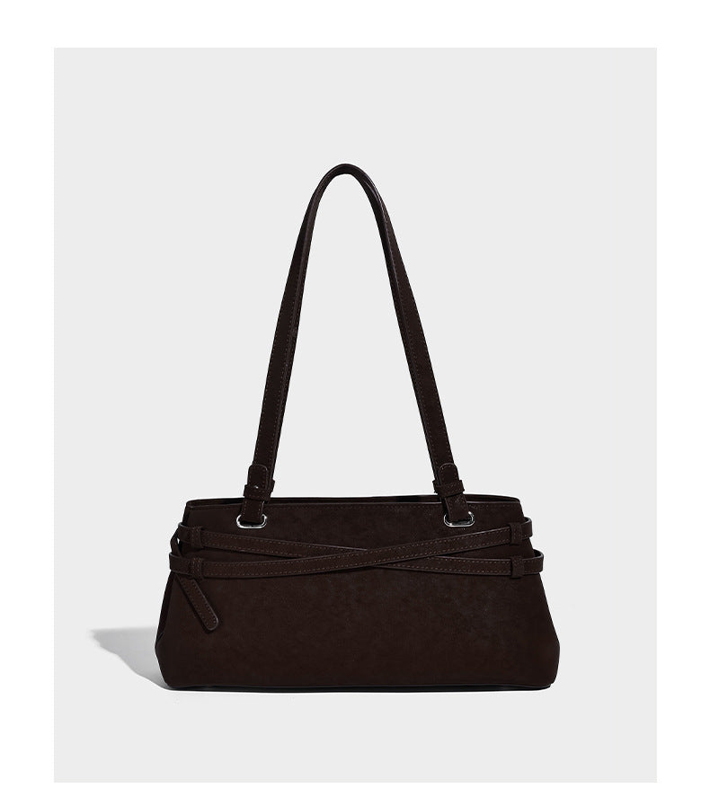 Structured trapezoid shoulder tote in dark brown matte suede-look finish with dual straps, wraparound belt bands