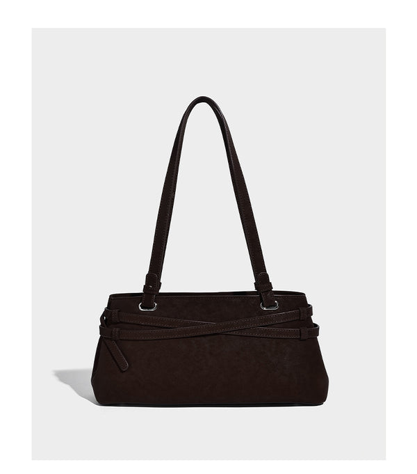 Structured trapezoid shoulder tote in dark brown matte suede-look finish with dual straps, wraparound belt bands