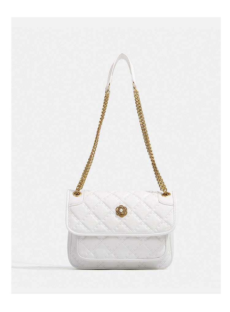 Compact diamond-quilted flap shoulder bag with gold-tone chain strap and floral turn-lock clasp, detail view 11