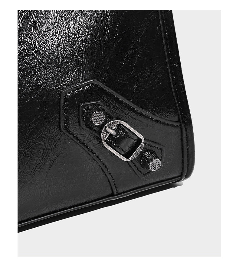 Large structured leather-look tote bag with front zip pocket, moto hardware accents, and long double shoulder straps, detail