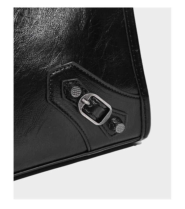 Large structured leather-look tote bag with front zip pocket, moto hardware accents, and long double shoulder straps, detail