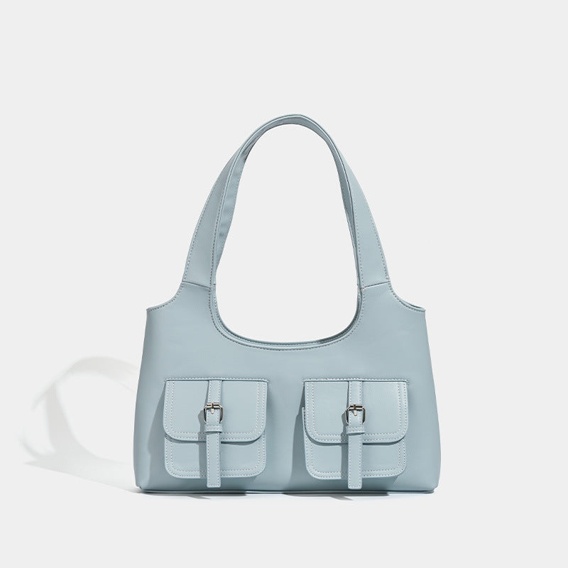 Powder blue structured tote bag with dual front flap buckle pockets and silver-tone hardware, front view