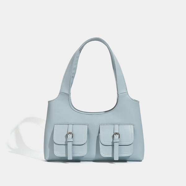 Powder blue structured tote bag with dual front flap buckle pockets and silver-tone hardware, front view
