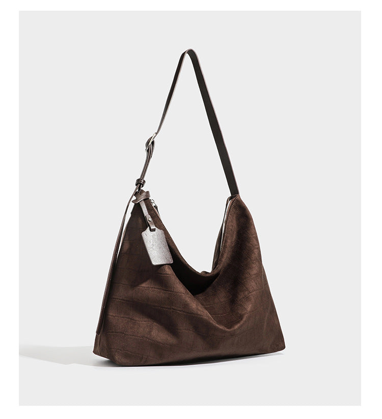 Slouchy hobo shoulder bag in matte croc-embossed leather-look finish with top zip closure and long adjustable strap, detail