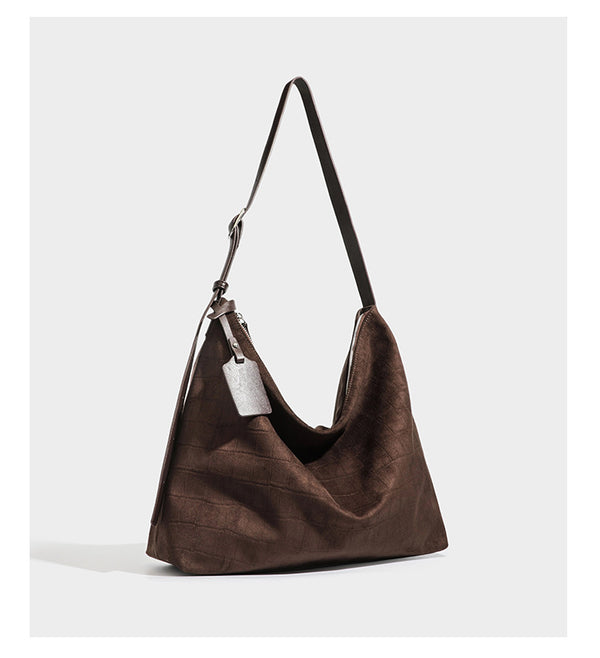Slouchy hobo shoulder bag in matte croc-embossed leather-look finish with top zip closure and long adjustable strap, detail