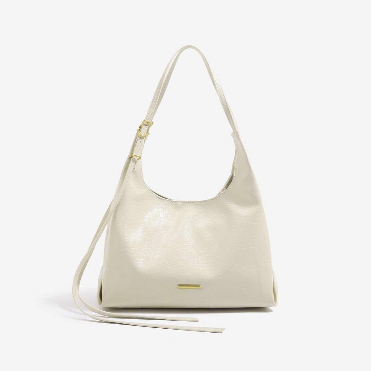 Slouchy hobo shoulder bag in crinkle high-gloss leather-look finish with gold-tone bar hardware and adjustable strap, detail