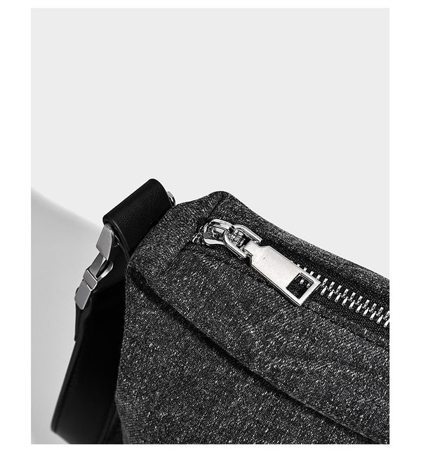Charcoal denim-textured slouchy hobo bag with zip-top closure, silver-tone hardware, and adjustable leather-look crossbody
