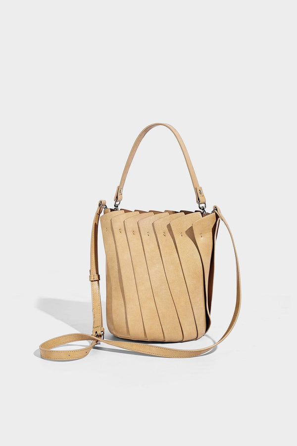 Structured pleated-panel bucket bag with curved top handle and detachable adjustable shoulder strap in smooth matte, detail