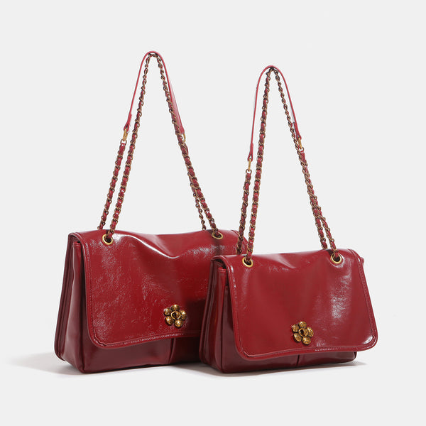 Structured glossy flap shoulder bag with antique gold floral turn-lock clasp and chain-and-leather strap, detail view 2