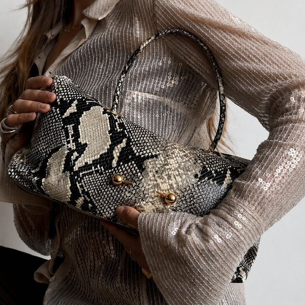 Wide embossed-texture shoulder tote bag with single loop handle and gold-tone toggle hardware, detail view 2