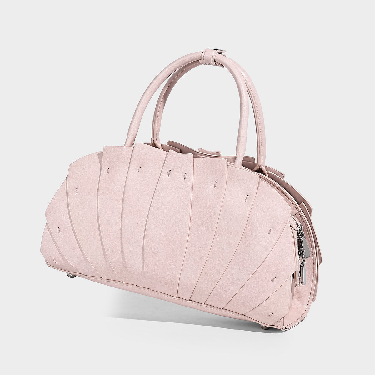 Structured dome satchel with fan-pleated leather-look exterior, dual top handles, and detachable shoulder strap, detail view