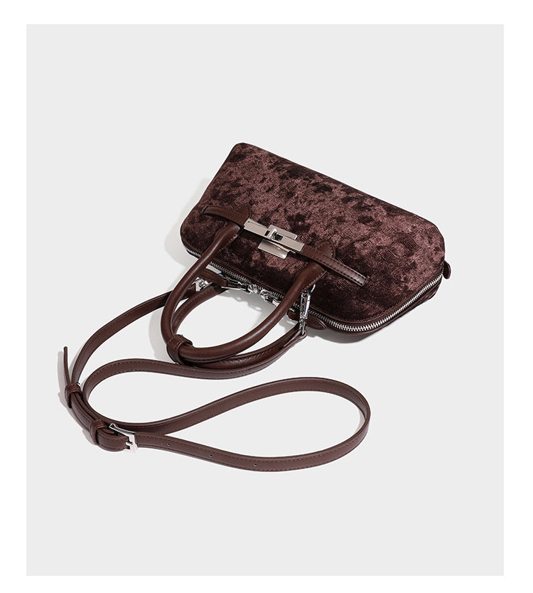 Small structured satchel bag in dark brown velvet-like textured finish with leather-look trim, silver-tone turn-lock bar