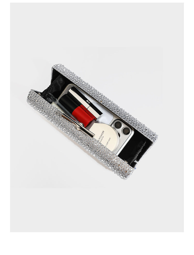 Structured rectangular hard-case clutch bag covered in all-over rhinestone crystal embellishment with curved kiss-lock top