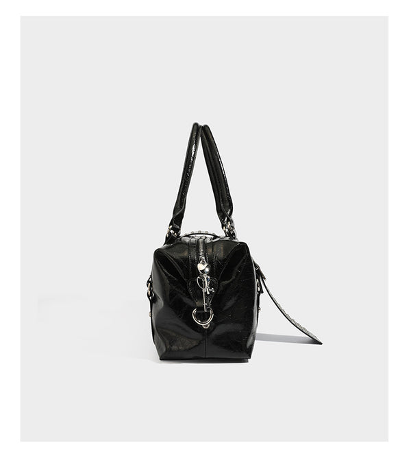 Glossy crinkled barrel handbag with silver stud buckle strap and detachable shoulder strap, detail view 9