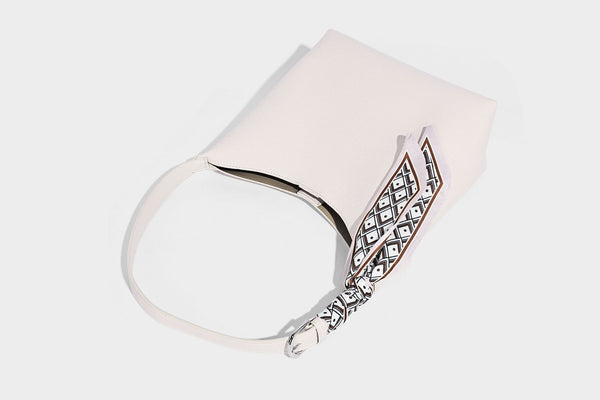 Soft slouchy hobo shoulder bag in pebbled matte finish with slim strap, silver-tone ring hardware, and knotted printed scarf
