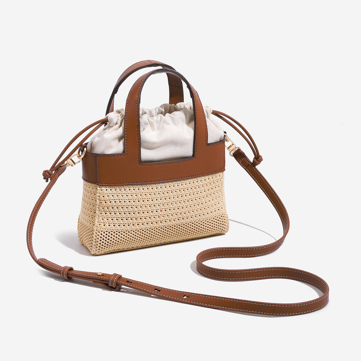 Small woven open-weave bucket bag with brown leather-look trim, cream gathered drawstring lining, dual top handles, and