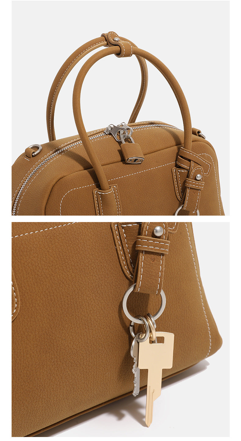 Compact retro Boston satchel bag with matte suede-look finish, twin rounded top handles, double zip closure with silver-tone